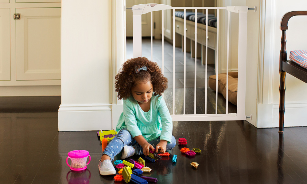 Girl sat next to a stair gate